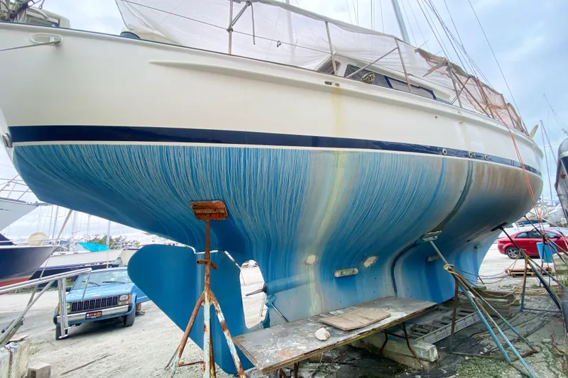 Slide: The Image of 1966 Vanguard Bermudian Sloop in dry dock, showcasing blue hull and keel. - 3