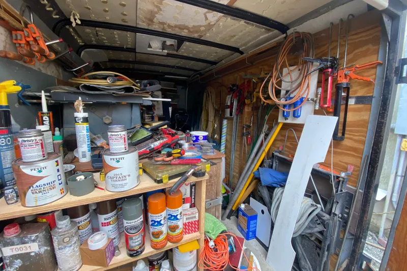 Slide: The Image of Workshop interior with tools, paint cans, and supplies for a 1966 Vanguard Bermudian Sloop. - 31