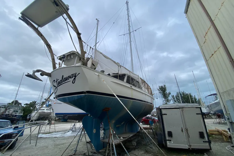 Slide: The Image of 1966 Vanguard Bermudian Sloop sailboat in dry dock, overcast sky background. - 5