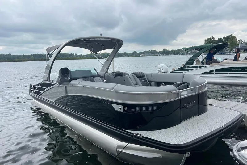 The Image of 2026 Bennington RX 25 RXFBA pontoon boat docked on a cloudy day. - 0