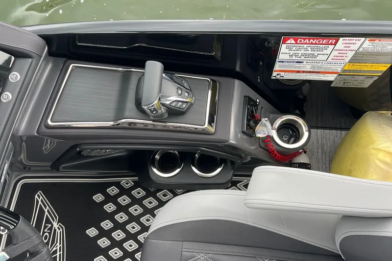 Slide: The Image of Interior view of 2026 Bennington RX 25 RXFBA boat console with controls and safety warnings. - 10