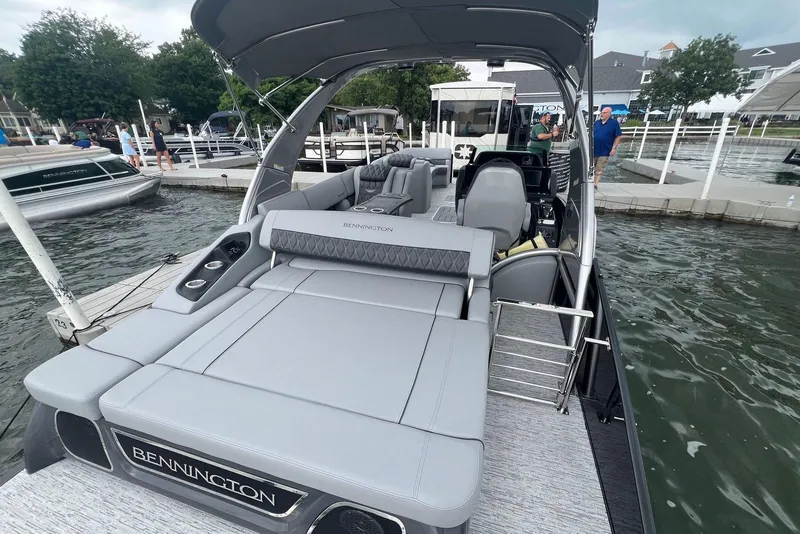 Slide: The Image of 2026 Bennington RX 25 RXFBA luxury pontoon boat docked at marina. - 11