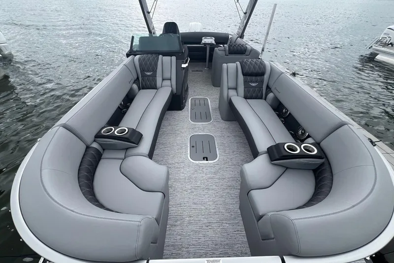 Slide: The Image of Luxurious 2026 Bennington RX 25 RXFBA pontoon boat interior with plush gray seating. - 3