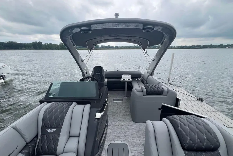 Slide: The Image of Luxury 2026 Bennington RX 25 RXFBA pontoon boat with elegant seating on a serene lake. - 6