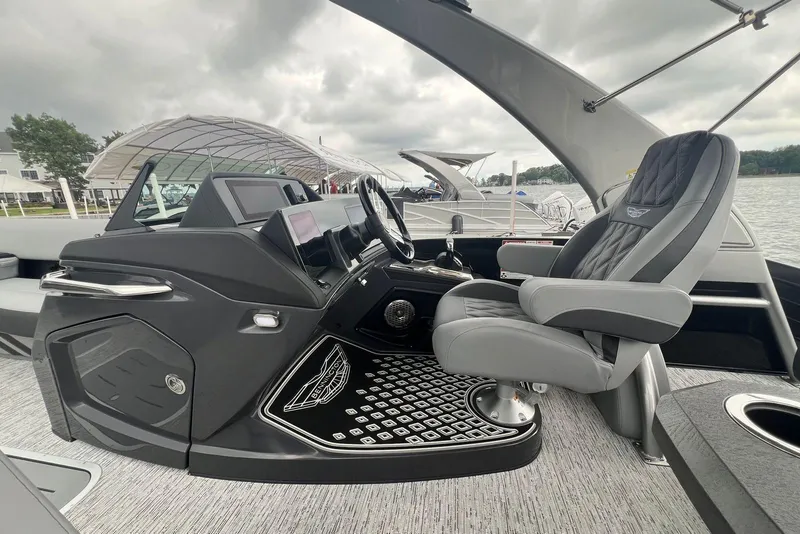 Slide: The Image of Luxurious interior of 2026 Bennington RX 25 RXFBA boat with sleek captain's chair and modern dashboard. - 8