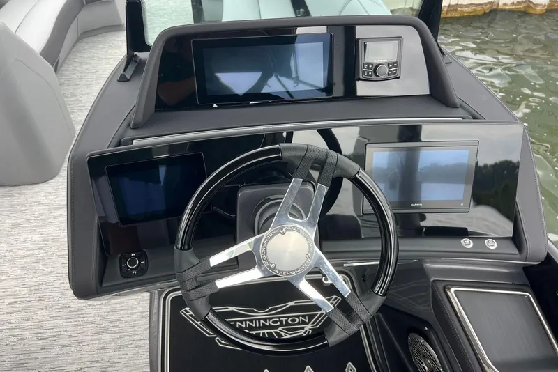 Slide: The Image of 2026 Bennington RX 25 RXFBA boat dashboard with modern steering and digital displays. - 9