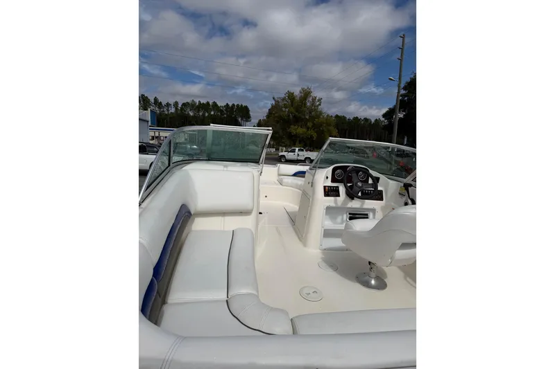 Slide: The Image of 2012 Hurricane SunDeck 187 OB boat interior with white seating and dashboard. - 10