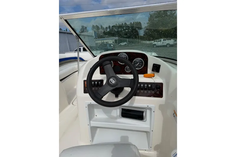 Slide: The Image of 2012 Hurricane SunDeck 187 OB boat dashboard with steering wheel and gauges. - 14