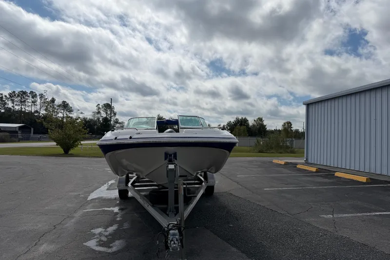 Slide: The Image of 2012 Hurricane SunDeck 187 OB boat on trailer under cloudy sky. - 3