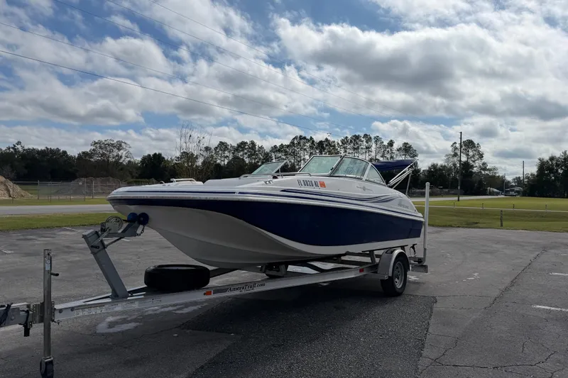 Slide: The Image of 2012 Hurricane SunDeck 187 OB boat on trailer under cloudy sky. - 4