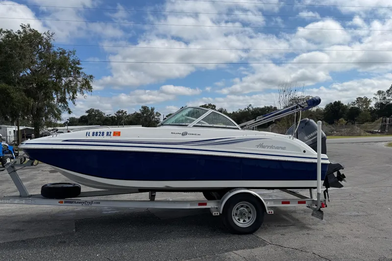 Slide: The Image of 2012 Hurricane SunDeck 187 OB boat on trailer under cloudy sky. - 5