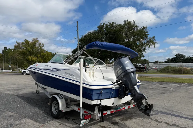 Slide: The Image of 2012 Hurricane SunDeck 187 OB boat on trailer, featuring Yamaha outboard motor. - 6
