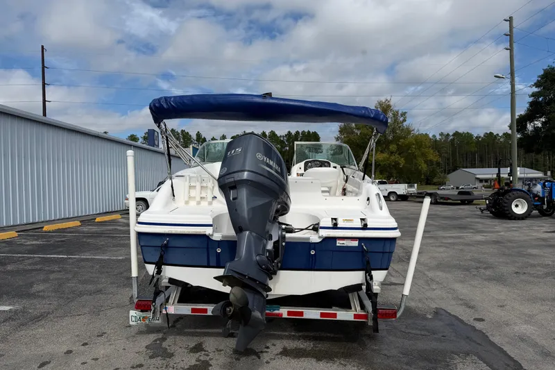 Slide: The Image of 2012 Hurricane SunDeck 187 OB boat with Yamaha outboard motor on a trailer. - 7