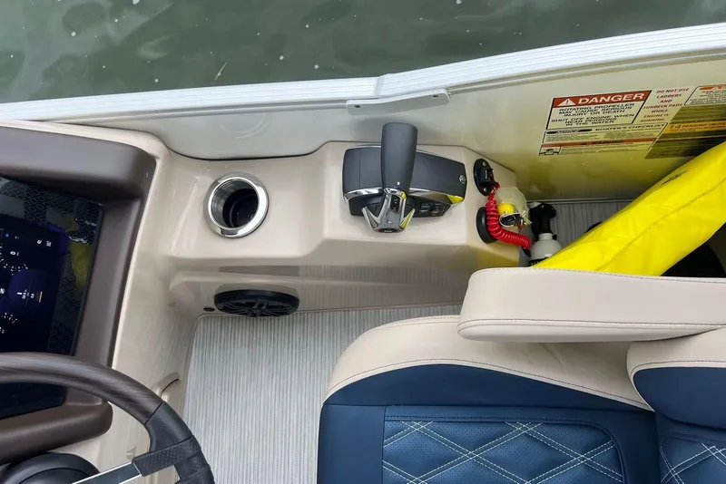 Slide: The Image of Interior of 2026 Bennington 25 RTFBA boat with control panel and seating. - 11