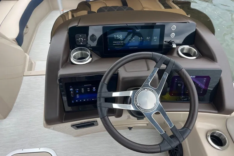 Slide: The Image of Steering console of 2026 Bennington 25 RTFBA boat with digital displays and controls. - 12