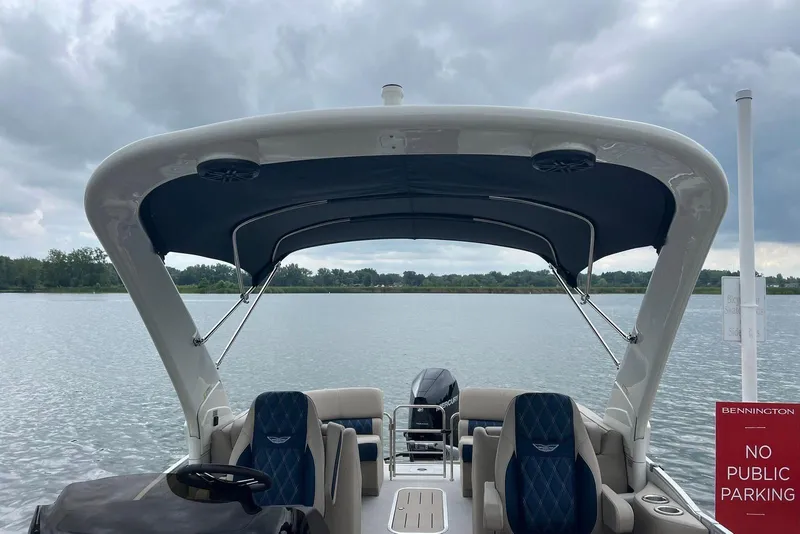 Slide: The Image of 2026 Bennington 25 RTFBA boat on a lake under cloudy skies. - 13