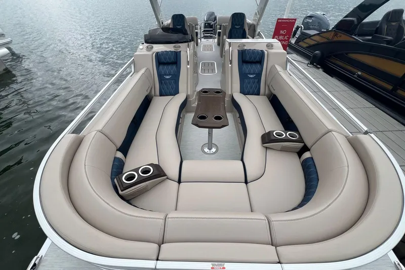 Slide: The Image of Luxurious 2026 Bennington 25 RTFBA pontoon boat with plush seating and cup holders. - 2