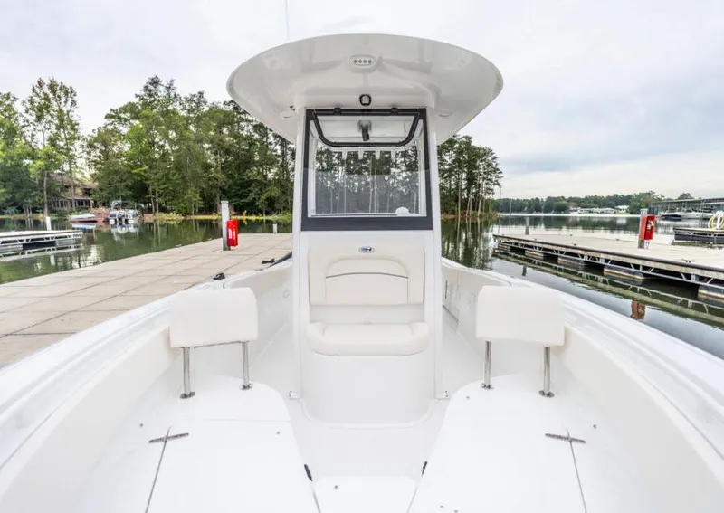 Slide: The Image of Manufacturer Provided Image: 2026 Sea Hunt Ultra 245 SE boat docked, showcasing spacious seating and sleek design. - 2