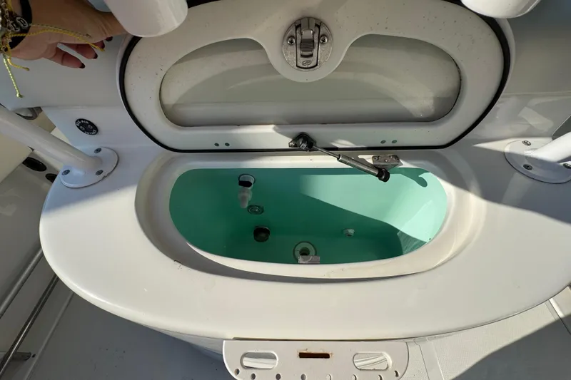 Slide: The Image of Livewell compartment on a 2015 NauticStar 2500XS Offshore boat, open and ready for use. - 10