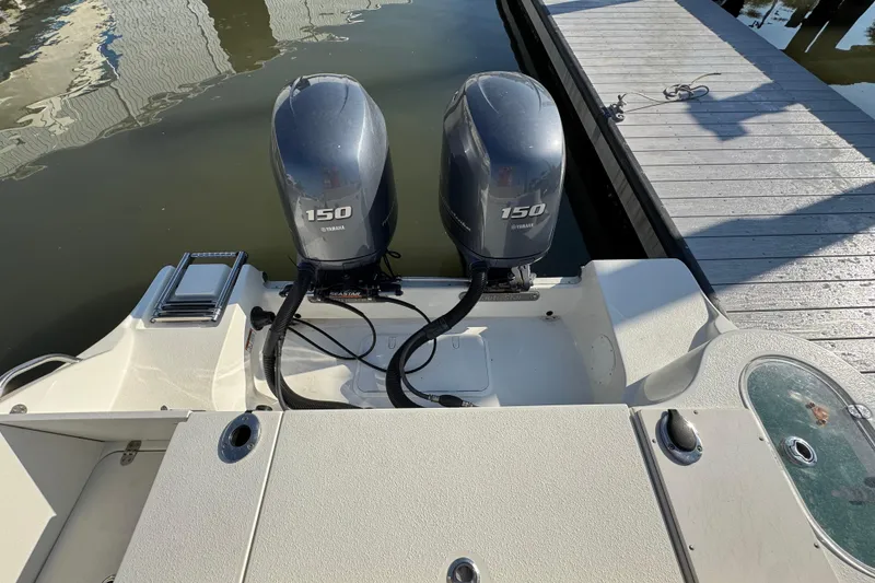 Slide: The Image of 2015 NauticStar 2500XS Offshore boat with twin Yamaha 150 engines at dock. - 11