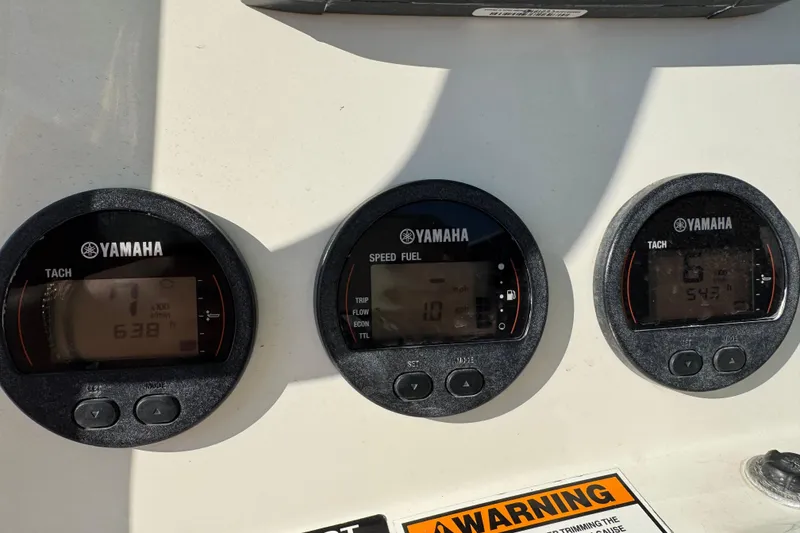 Slide: The Image of Yamaha gauges on 2015 NauticStar 2500XS Offshore boat dashboard. - 2