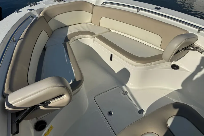 Slide: The Image of 2015 NauticStar 2500XS Offshore boat interior with cushioned seating and storage compartments. - 3