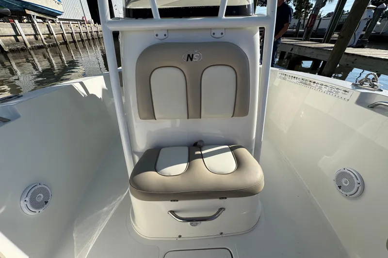 Slide: The Image of 2015 NauticStar 2500XS Offshore boat seat with beige and white upholstery. - 5