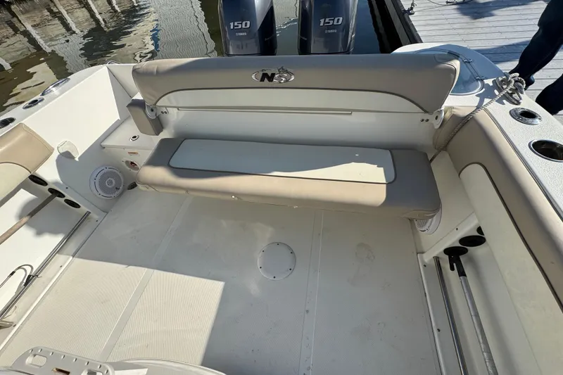 Slide: The Image of 2015 NauticStar 2500XS Offshore boat interior with seating and Yamaha engines. - 8