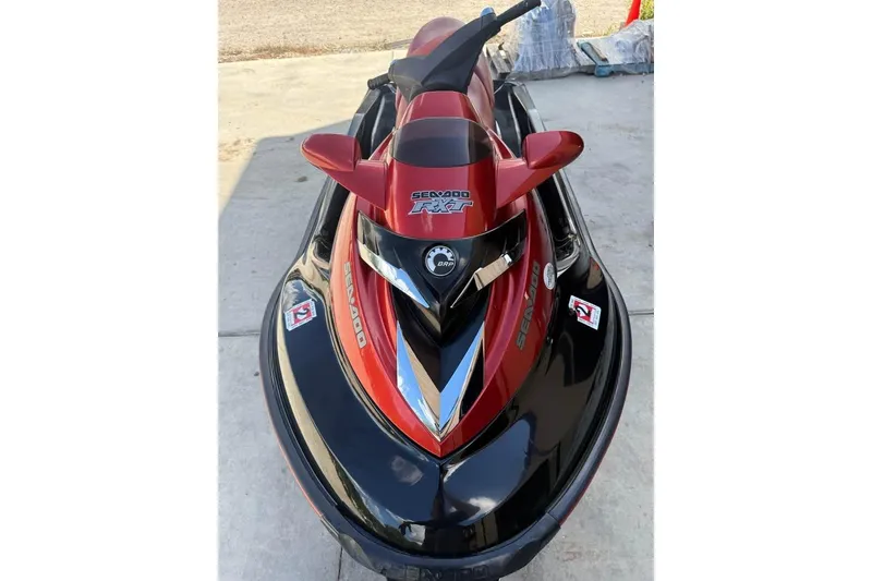 Slide: The Image of 2008 Seadoo RXT jet ski in red and black, parked on concrete. - 4