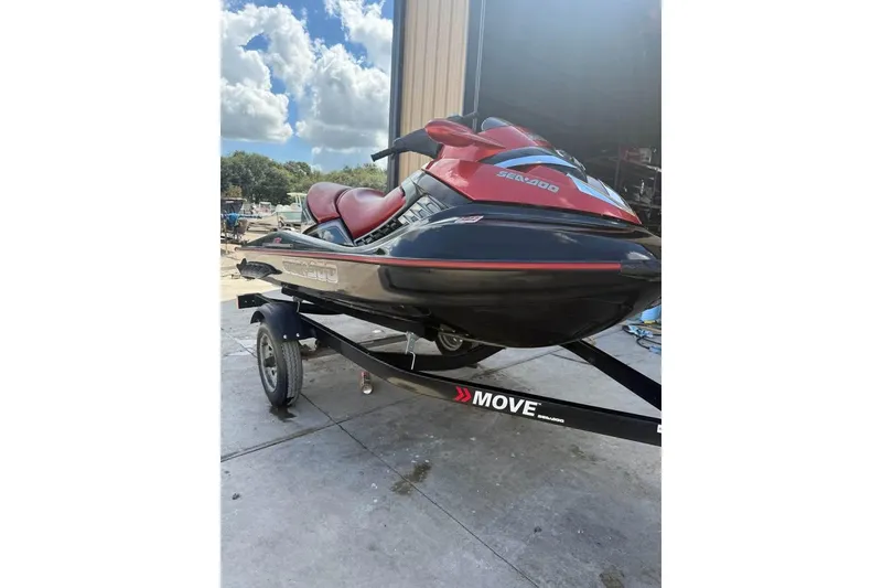 Slide: The Image of 2008 Seadoo RXT jet ski on trailer, parked outdoors under a cloudy sky. - 5