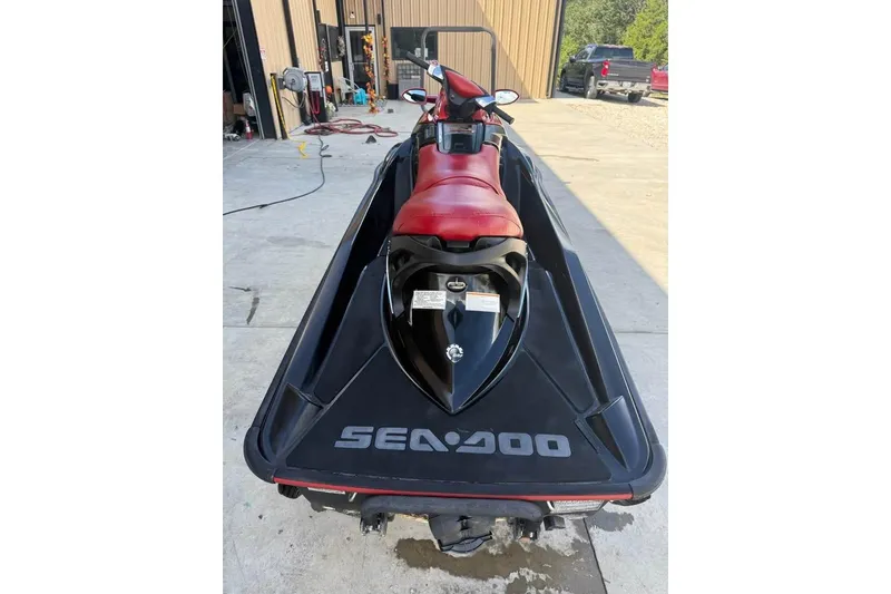 Slide: The Image of 2008 Seadoo RXT jet ski with red seat, parked on concrete. - 6