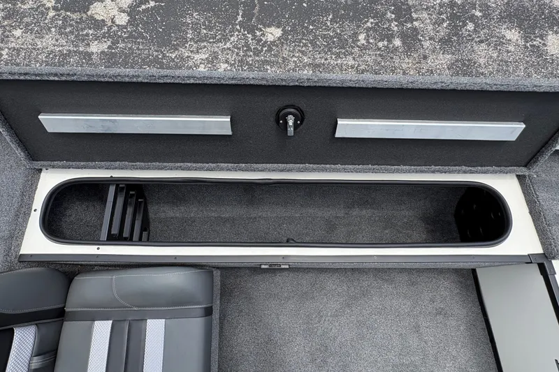 Slide: The Image of 2026 Ranger RT188C boat interior storage compartment with gray upholstery. - 11