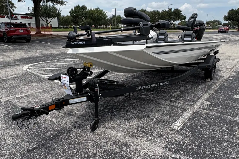 The Image of 2026 Ranger RT188C boat on trailer in parking lot under cloudy sky. - 0