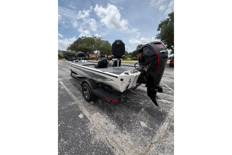 Slide: The Image of 2026 Ranger RT188C boat with powerful outboard motor, parked on asphalt under cloudy sky. - 8