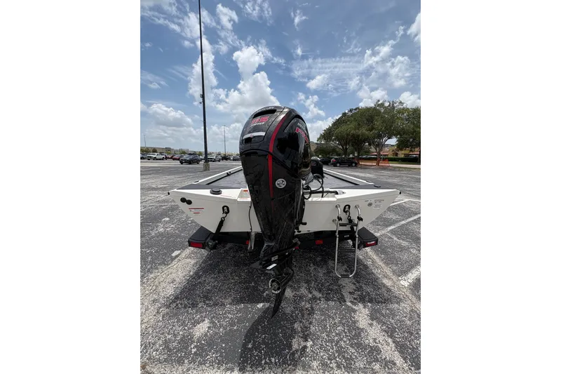 Slide: The Image of 2026 Ranger RT188C boat with powerful outboard motor in a parking lot. - 9
