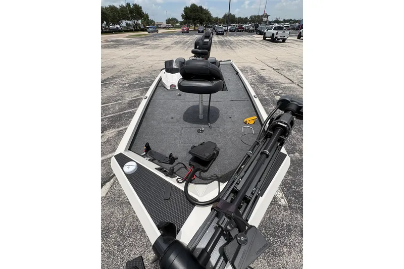 Slide: The Image of 2026 Ranger RT188C fishing boat with seating and equipment on a parking lot. - 2