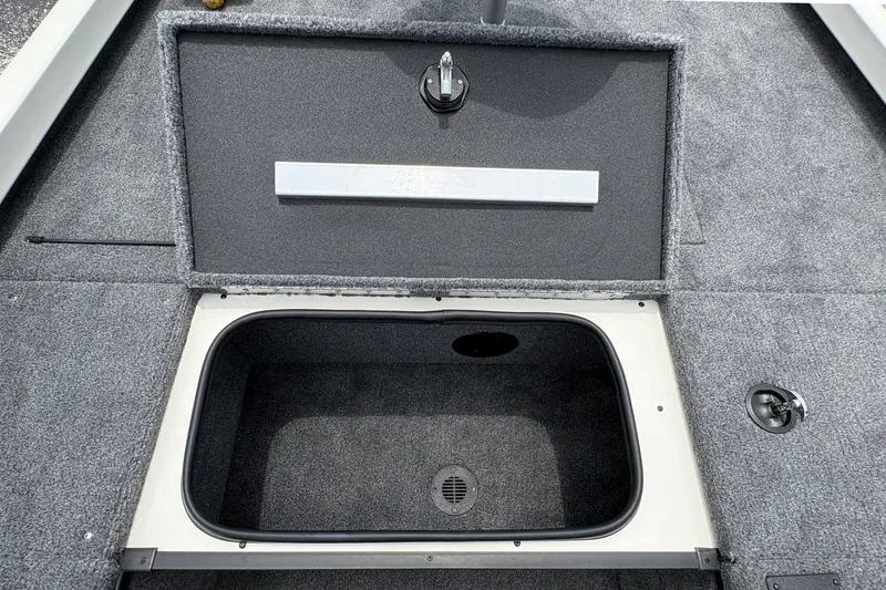 Slide: The Image of 2026 Ranger RT188C boat storage compartment with open lid, showcasing interior space. - 12