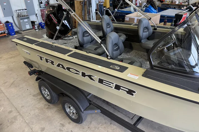 The Image of 2026 Tracker Targa V-19 Combo boat in a workshop, featuring multiple seats and a sleek design. - 0