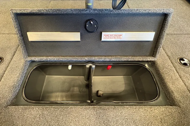 Slide: The Image of 2026 Ranger RT198P boat storage compartment with open lid, showcasing interior space. - 19