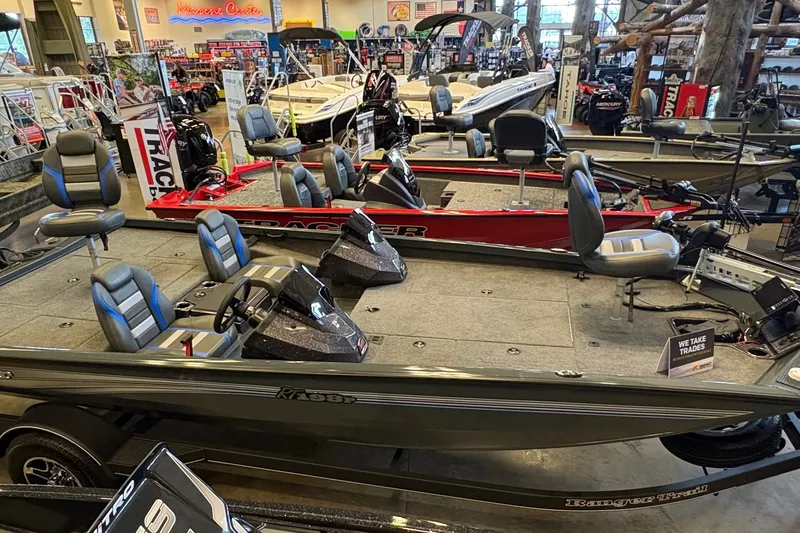 Slide: The Image of 2026 Ranger RT198P fishing boats displayed in a showroom with seating and controls. - 2