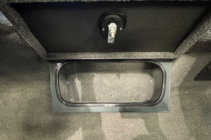 Slide: The Image of 2026 Ranger RT198P boat storage compartment with carpeted interior and latch mechanism. - 12