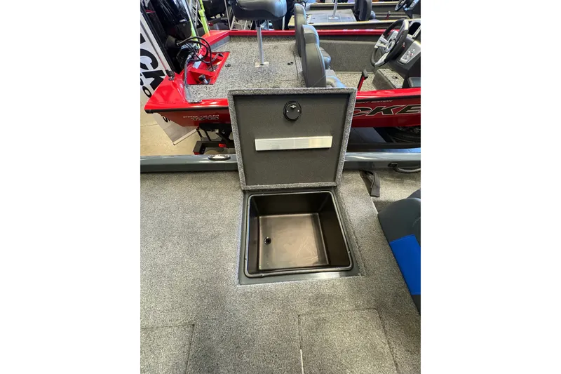 Slide: The Image of 2026 Ranger RT198P boat interior with open storage compartment, gray carpet, and red accents. - 18