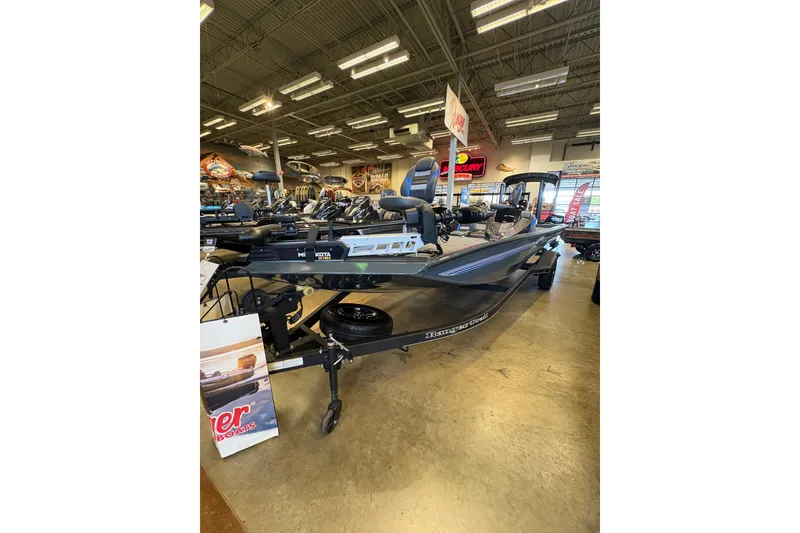Slide: The Image of 2026 Ranger RT198P boat displayed in a showroom with fishing equipment. - 7