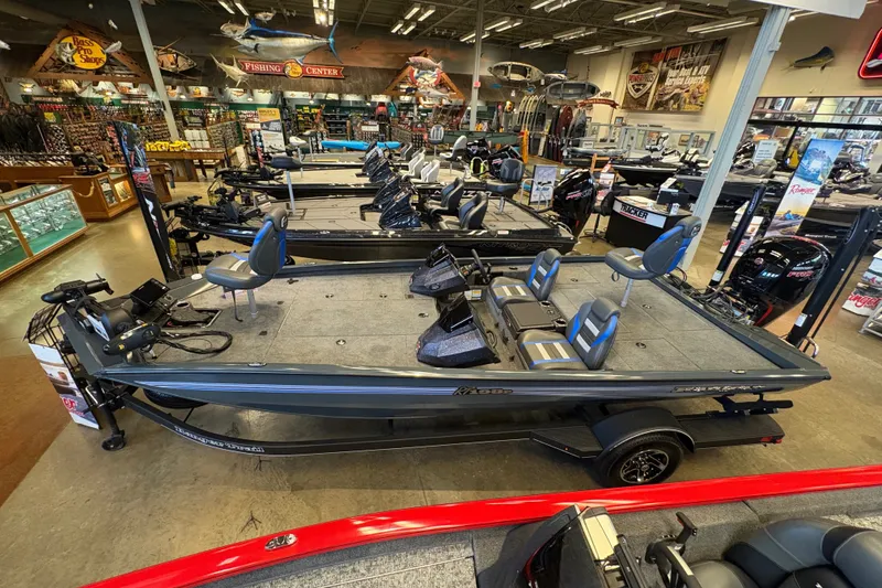 Slide: The Image of 2026 Ranger RT198P fishing boat displayed in a showroom with various equipment. - 6
