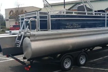 Slide: The Image of 2026 Sun Tracker SportFish 22 XP3 pontoon boat on trailer in parking lot. - 3