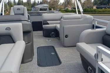 Slide: The Image of 2026 Sun Tracker SportFish 22 XP3 pontoon boat interior with plush seating and spacious layout. - 9
