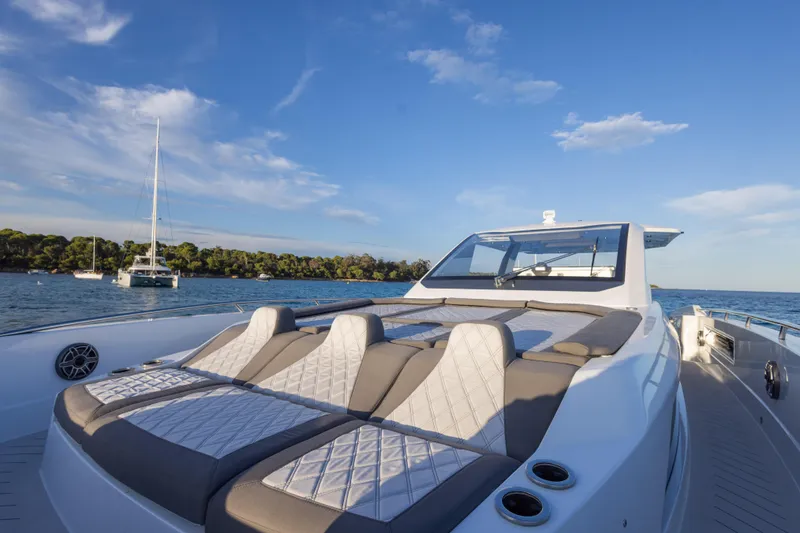 Slide: The Image of Luxurious 2025 Canados 571 yacht with sunbathing deck on serene water. - 13