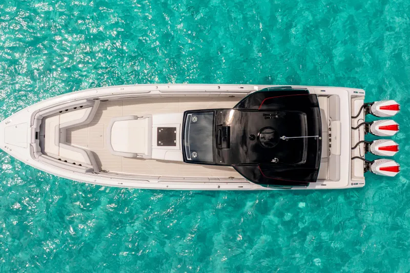 Slide: The Image of Aerial view of 2025 Cigarette 41 Nighthawk boat on turquoise water. - 2