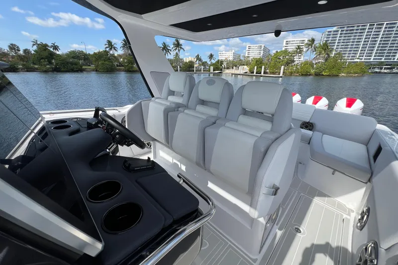 Slide: The Image of 2025 Cigarette 41 Nighthawk boat interior with luxurious seating and modern dashboard. - 23