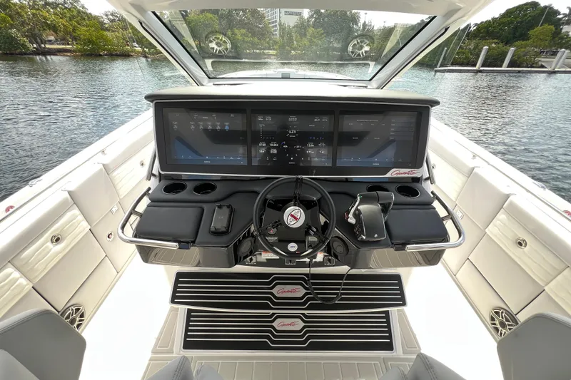 Slide: The Image of 2025 Cigarette 41 Nighthawk boat cockpit with advanced navigation screens and controls. - 24